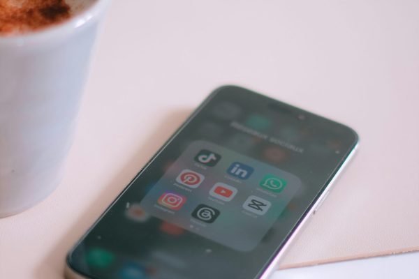 a cup of coffee next to a cell phone